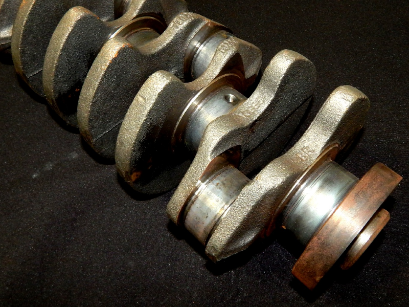 General view of the nodular cast iron crankshaft, 240 mm long, in process of heat treatment.  The main and rod bearings, 54 mm diameter, are heat treated  by localized quenching and tempering.