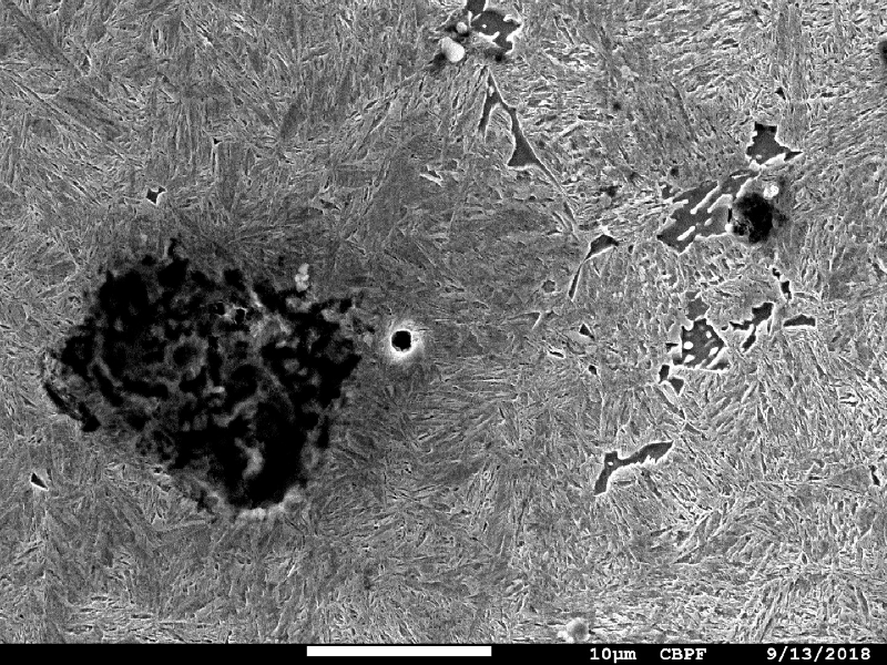 Micrography of the shaft at the surface in a heat treated position.  The graphite nodule is degradating due to temperature and adjacent the microsctructure is martensitic.