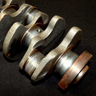 General view of the nodular cast iron crankshaft, 240 mm long, in process of heat treatment.  The main and rod bearings, 54 mm diameter, are heat treated  by localized quenching and tempering.
