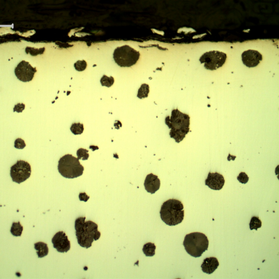 As polished micrography of the crankshaft at the shaft edge, close to the surface.  Graphite in nodules.