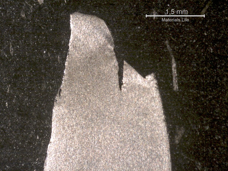 Macrography of one wire that was overloaded, showing localized necking and large plastic deformation close to the fracture. This kind of fracture occurred for about 25% of the broken wires.