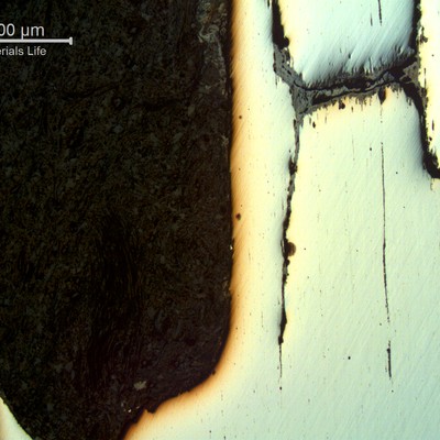 Micrography of a typical as polished corrosion-fatigue mechanism, in a longitudinal section. The loss of material is accelerated a lot by the cracks through the thickness.