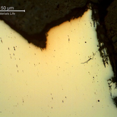 Micrography of a typical as polished overloaded wire, in a longitudinal section, showing necking at the fracture and secondary ductile cracks.  About 25% of the wires have ruptured by this ductile mechanism.
