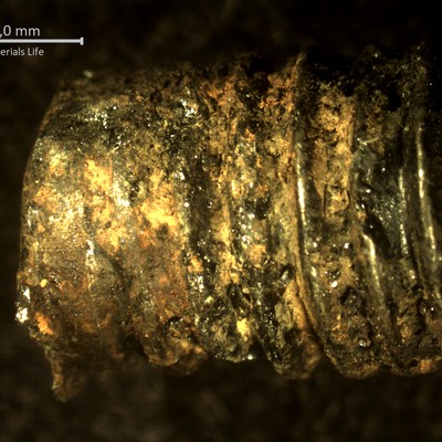 Low magnification microscope image showing the aspect of the thread close to the fracture surface.  Looks like a wear or strong corrosion, but in fact the threads were removed because they were cracked, as can be seen in the next figures.