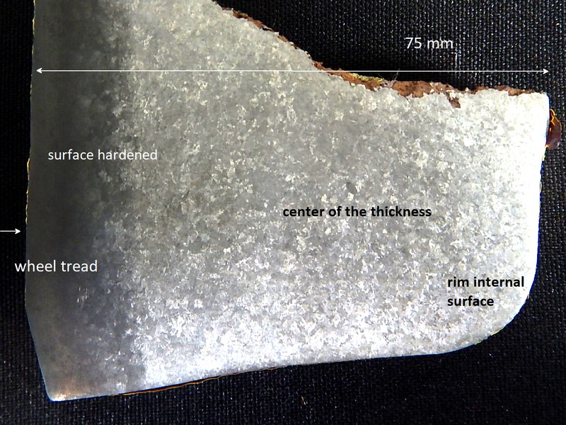 Macrography of a wheel section close to the tread, where the material receives a localized surface hardening by quenching and tempering.  The average hardness at the surface is 346HB and in the center is 196HB.   The wheel was in operation for a long time and the analyzed part is at the wheel tread.