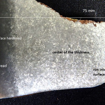 Macrography of a wheel section close to the tread, where the material receives a localized surface hardening by quenching and tempering.  The average hardness at the surface is 346HB and in the center is 196HB.   The wheel was in operation for a long time and the analyzed part is at the wheel tread.