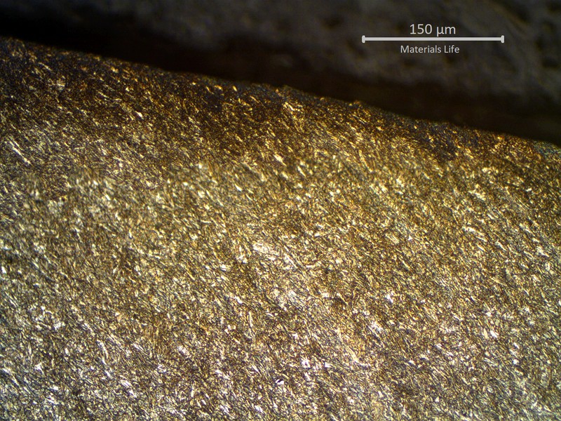 Micrographic detail of sheared pipe, showing strong plastic deformation at the fracture.  All the structure is deformed in the direction of the failure shearing.