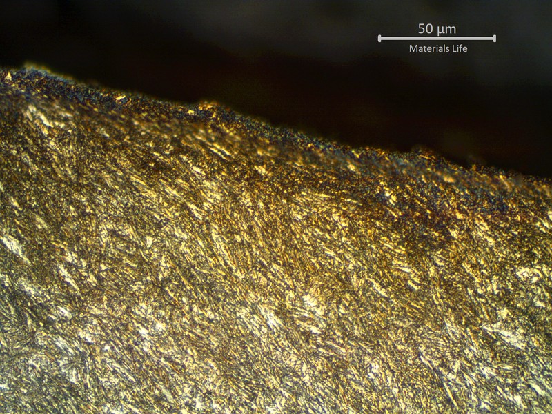 Micrographic detail of sheared pipe, showing strong plastic deformation at the fracture.  The structure shows the shear effect at the fracture.