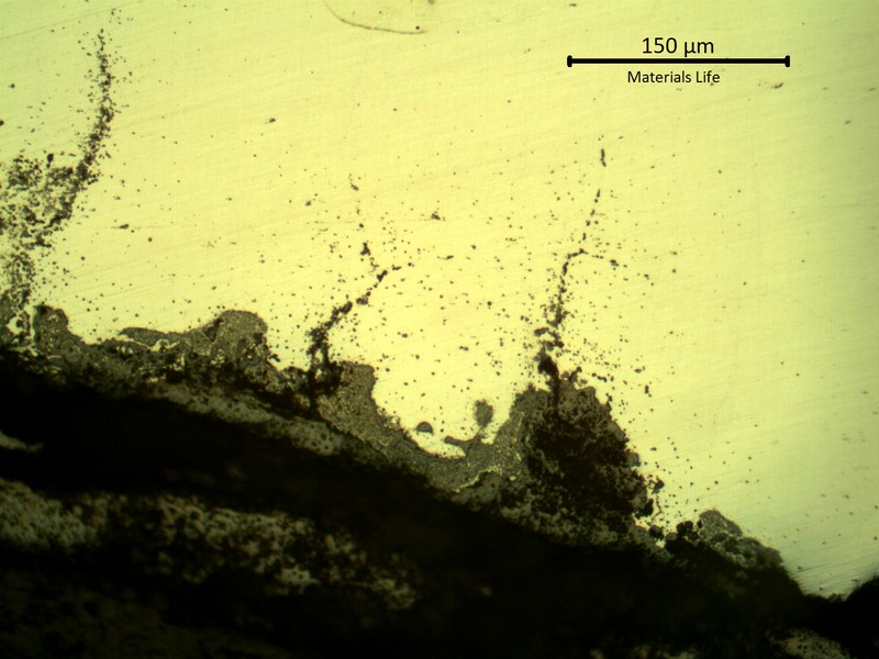SAMPLE 1, CLOSE TO THE SURFACE OF SIDE A - Micrography, as polished, of the oxides at the process side.  In this region the oxide layer is penetrating into the austenitic grain boundaries, creating a crack like effect.