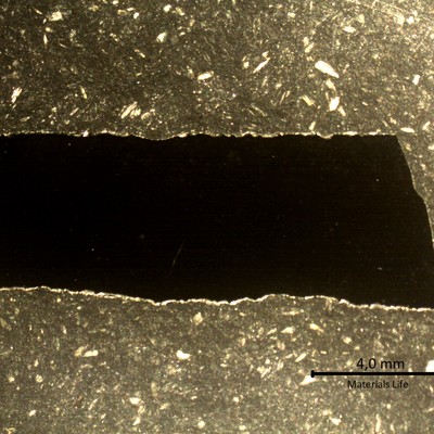 Longitudinal section macrography of the plate where the degradation by thinning is reducing the thickness from 6mm to 4mm (sample 3). The thinning is occurrring from the product reaction side (side A to the bottom of the figure).