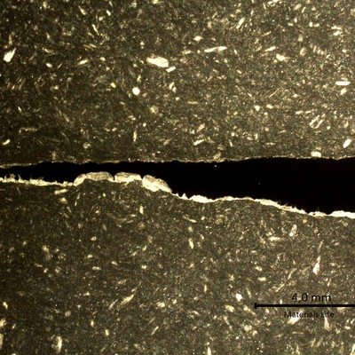 Transverse section macrography of the plate where the degradation by thinning is worst, close to the original corners of the tube. The thinning is occurrring from the product reaction side (side A to the bottom of the figure). The macrography shows a reduction in the thickness from 2 mm (right side, sample 2) to almost zero (left side, sample 1).