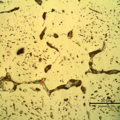 SAMPLE 3 AT 4 mm THICKNESS - Micrographic detail of the material in the center of the thickness, longitudinal section.  The microstructure is austenitic and the coloured phases are sigma, at austenitic grain boundaries.