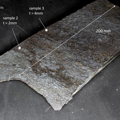 Aspect as received, side A, of the part removed from the rectangular tube that was manufactured from plates, and originally presented two welded seams (not included in the sample).  Close to the edges of the sample, where probably were the corners of the rectangular tube, the degradation is in a highest level. Three samples were analysed, with different thicknesses (indicated in the figure).  Side A is the side that was in contact with the reaction (product side).