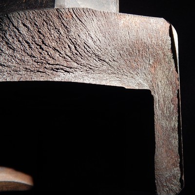 Fracture appearance of one side of the broken part showing chevron marks coming from the thinner part of the fracture.  The socket thickness is only 13 mm at this point.