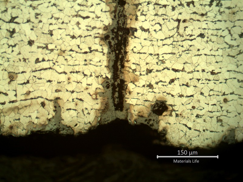 Micrography presenting the internal tube surface with several parallel cracks, some still in the beginning (less than 0.1 mm deep).