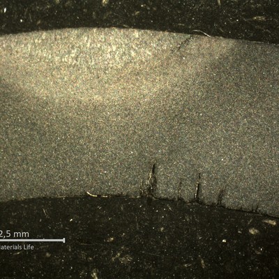 Macrography of the transverse section of the tube, in a position where the cracking was not yet through wall. The internal tube surface shows multiple corrosion fatigue cracks, parallel, under the weld of the membrane, probably related to the cold side of the tube (the cracks opened to the boiler outside).   The external side of the tube presenting a small crack at the margem of the weld, suggesting also the action of thermal stresses.