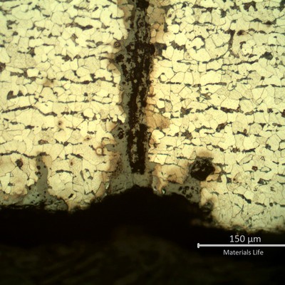 Micrography presenting the internal tube surface with several parallel cracks, some still in the beginning (less than 0.1 mm deep).