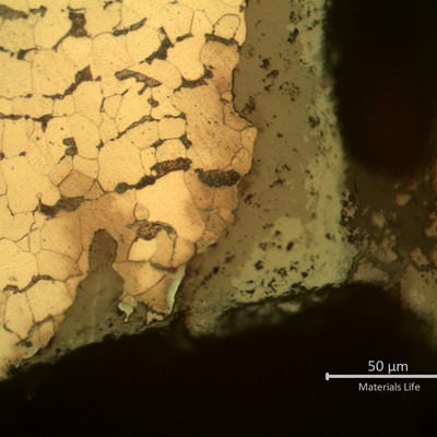 Micrographic detail of the parallel cracks growthing from pits.