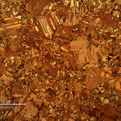 Micrography of the tranverse section of the tube, in the center of the thickness.  There are small grains and large grains, characterizing a dual grain size.  The large grains size is about 100 microns, more than 10 times larger than the average size of the smaller grains size.