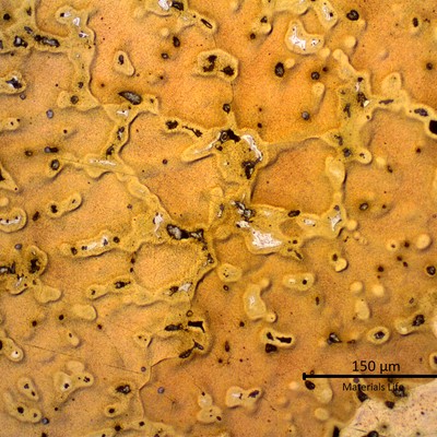 Micrography of a transverse section of the ring showing a cored alpha structure with strong segregation at interdendritic regions, and regions of a white structure at grain boundaries. This structure is in a region close to the center of the ring.
