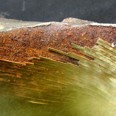 Region where the internal coating was detached.  The fracture at this position is flat.