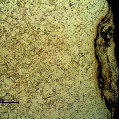 Micrographic detail of the strain hardening effect, probably generated by blasting  before applying the coating. The microstructure is tempered martensite and the surface it is slightly decarburized.