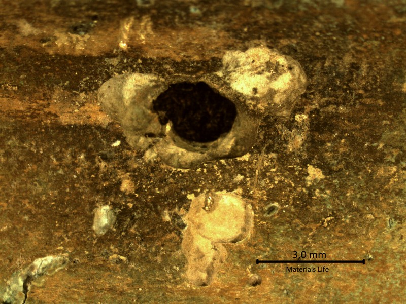 Detailed aspect, by a low magnification microscope, of the internal side of the tube, after longitudinal cut. The tube, that is 1.6mm thick, presented several points of localized corrosion leading to leaks.