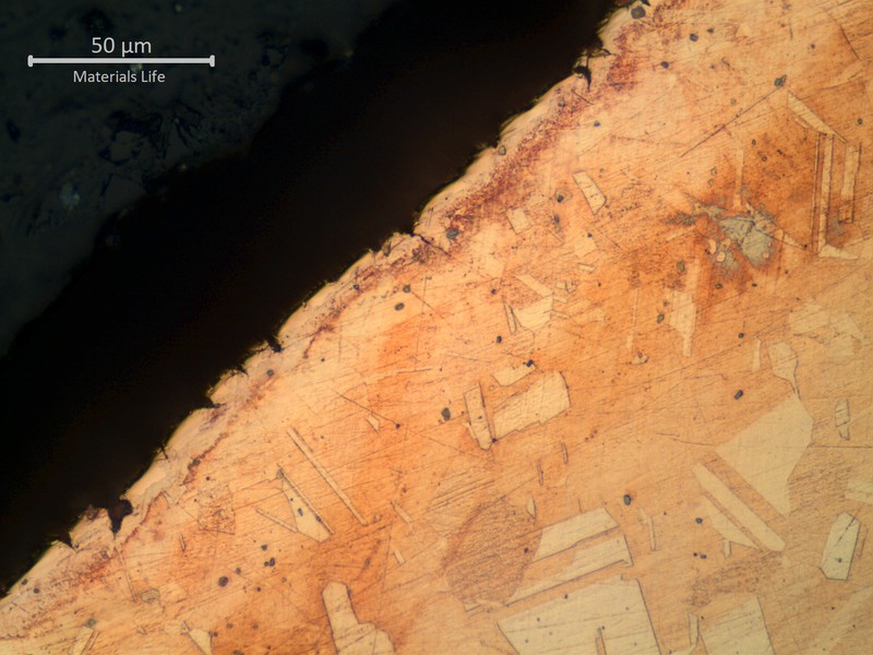 Micrographic detail of a transverse section of the tube at the localized reduced thickness point.  Close to the internal surface.