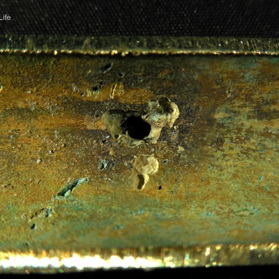 Visual aspect of the internal side of the tube, after longitudinal cut, presenting the region of leakage.  The tube, that is 1.6mm thick, presented several points of localized diissolution .