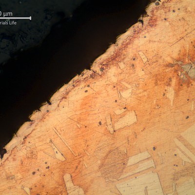 Micrographic detail of a transverse section of the tube at the localized reduced thickness point.  Close to the internal surface.