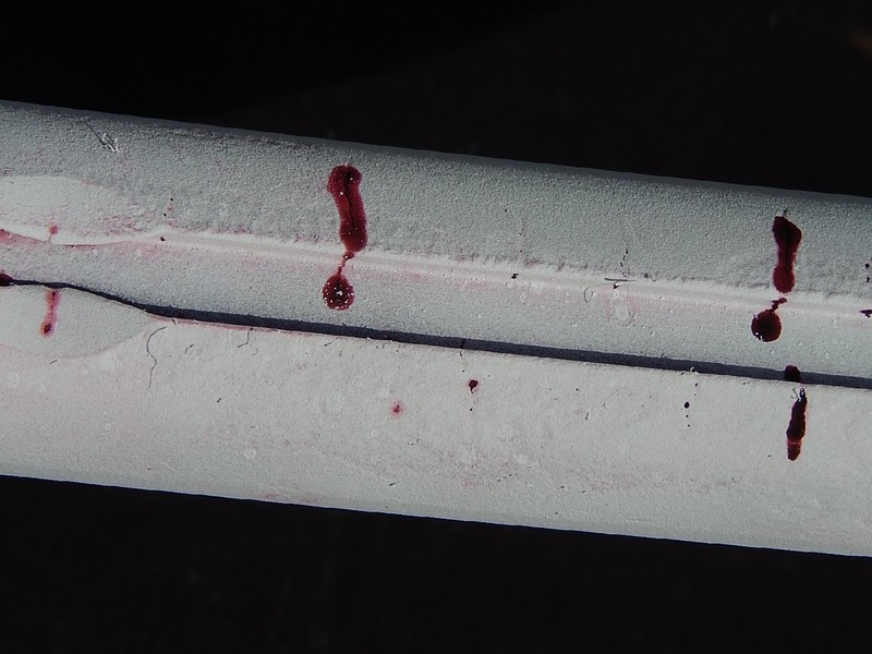 Dye check at the groove in the clamp ID, showing several parallel cracks, transverse to the clamp axis.