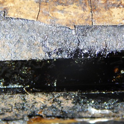 Detailed aspect of the cracks at the clamp substrate and at the coating.