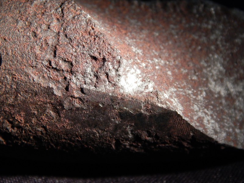 Surface to fracture interface. The spring shows corrosion and pits.