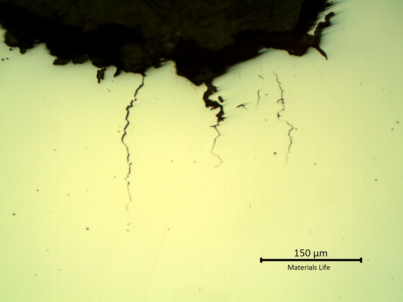 Micrographic aspect of the multiple intergranular cracks, initiating from the bottom of a pit.