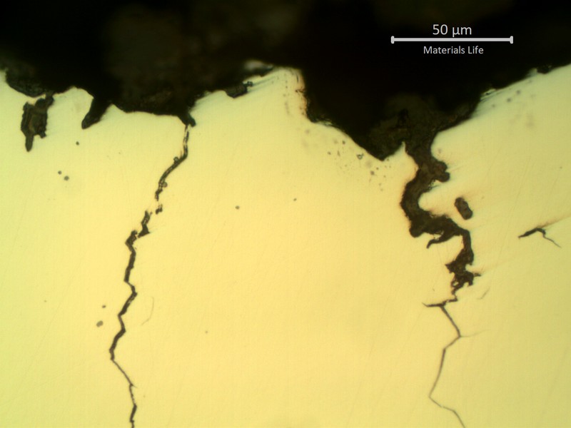 Micrographic detail of the intergranular cracks, initiating from the bottom of a pit.