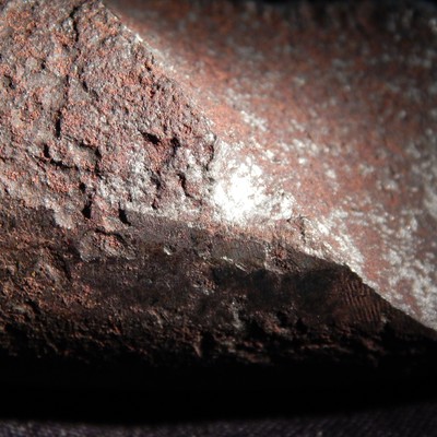 Surface to fracture interface. The spring shows corrosion and pits.