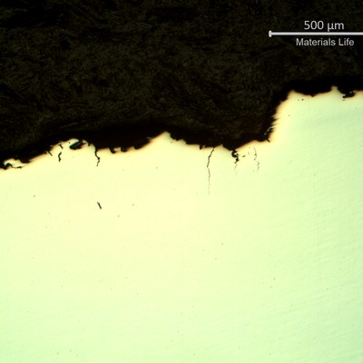 Micrography of a longitudinal section of the spring, at the surface, indicating that there are multiple intergranular cracks initiating from the pit.