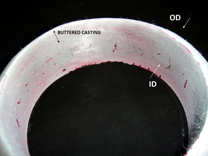After removal of the cracked part of the fitting, the dye check test indicated the presence of several cracks in the internal diameter (ID), out of the buttered layer, that means, in the fitting base metal.