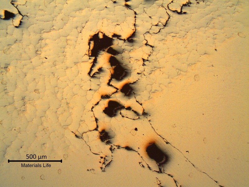 As polished micrography of the fusion line presenting several microcracks . The base metal is to the top and the weld metal is to the bottom.