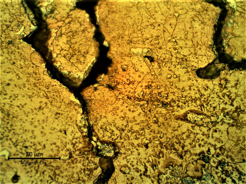 Micrographic detail of the cracks in the base metal created from the partially melted region suggesting that a liquation effect propagated brittle cracks into the low ductility base metal.
