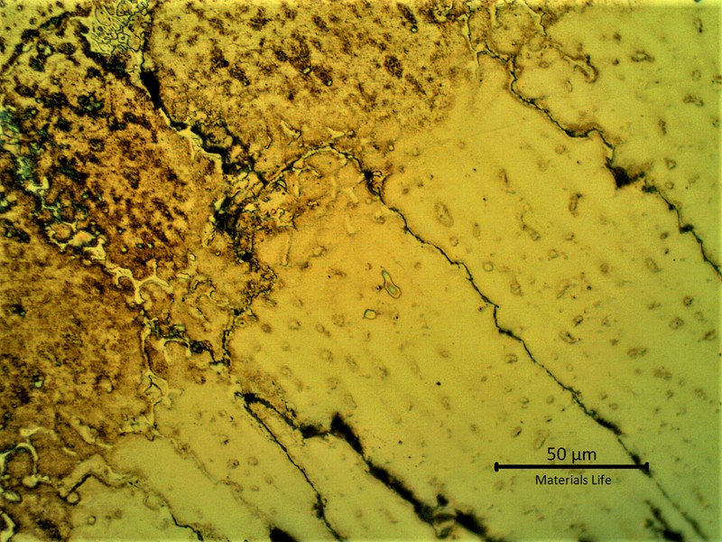 Micrographic detail of the cracks in the weld metal generated from the partially melted region at the fusion line suggesting that a liquation effect propagated a solidification cracking.