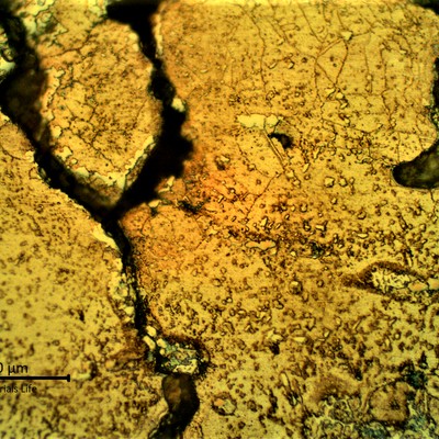 Micrographic detail of the cracks in the base metal created from the partially melted region suggesting that a liquation effect propagated brittle cracks into the low ductility base metal.