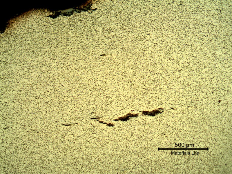Sample surface. Microstructure of the plate base metal, exposed to high temperature exhausting gases.  Refined austenite and some cracks.