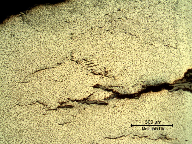 Sample surface. Microstructure of the weld metal, exposed to high temperature exhausting gases.  Austeno-ferritic structure and some cracks.