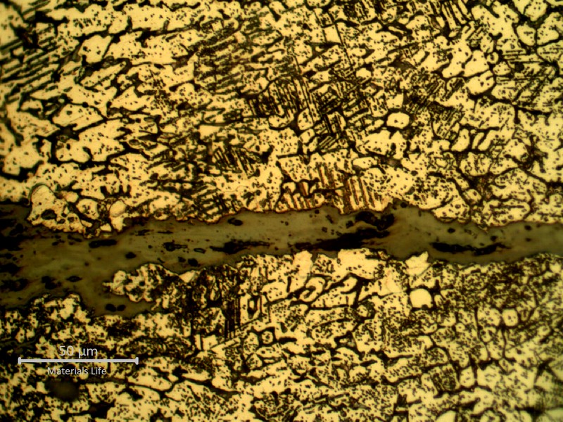 Detailed microstructure of the weld metal, exposed to high temperature exhausting gases.  Austeno-ferritic structure, strong carbide precipitation integranular and transgranular, and some cracks.