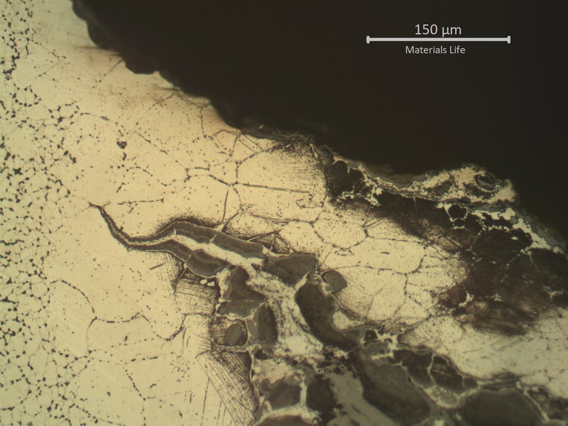 Microstructure of the heat affected zone (weld metal to the left side), exposed to high temperature exhausting gases. Large austenitic grain size and intergranular cracks fully opened and filled with oxides.