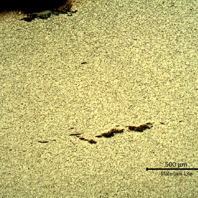 Sample surface. Microstructure of the plate base metal, exposed to high temperature exhausting gases.  Refined austenite and some cracks.