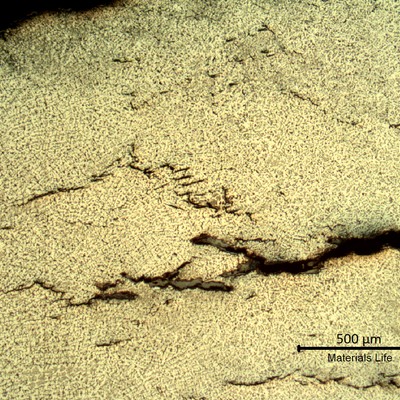 Sample surface. Microstructure of the weld metal, exposed to high temperature exhausting gases.  Austeno-ferritic structure and some cracks.