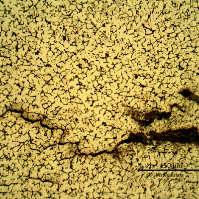 Detailed microstructure of the weld metal, exposed to high temperature exhausting gases.  Austeno-ferritic structure and some cracks.