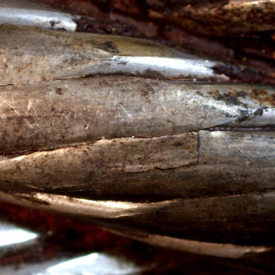 Detail of the cracks associated to deformed regions in the outer wire of a strand.